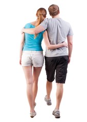 Back view of going young couple (man and woman). walking beautiful friendly girl and guy in shorts together. Rear view people collection. backside view of person.  Isolated over white background