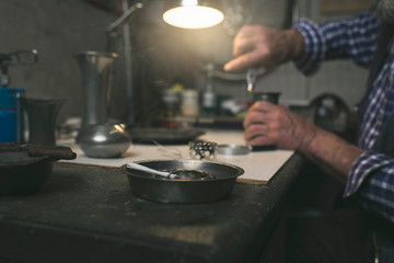 Cigarette on ashtray in workshop