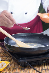 Chef putting minced garlic for cooking Pad Thai