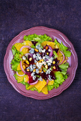 Fototapeta na wymiar Blue Cheese, Orange, Beetroot, Red Onion and Pistachios Salad. View from above, top studio shot