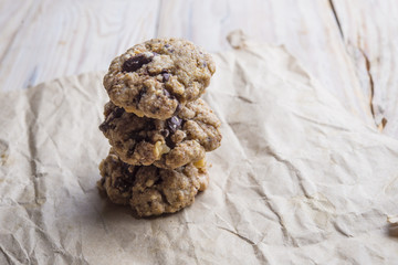 Chocolate cookies on white linen napkin on wooden table