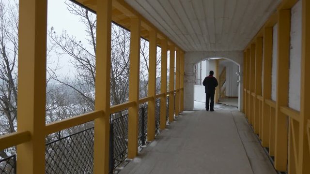 a Man Walks on the Long Terrace.