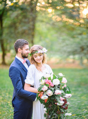 Lovers embrace each other on the wedding day in the park