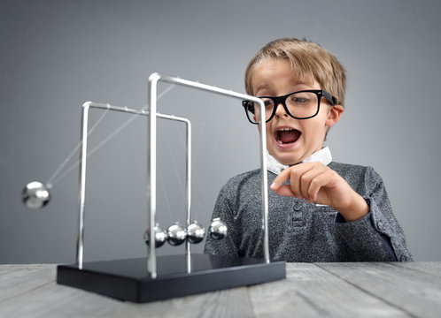 Physics and science education boy with Newton's cradle
