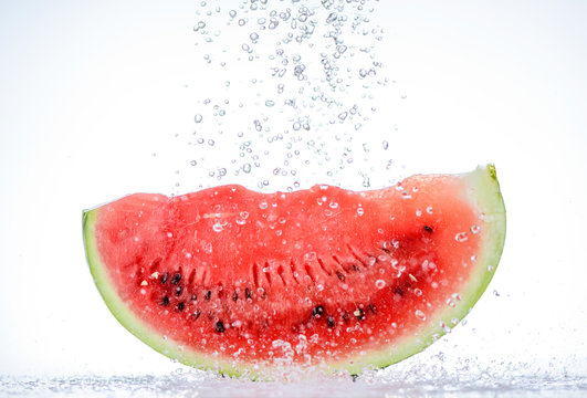 Red watermelon slice with splash of water