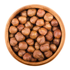 Hazelnuts in a wooden bowl on white background. Shelled ripe seeds of a cultivated Corylus species. Edible raw fruits. Isolated macro food photo close up from above.