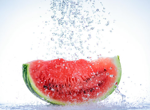 Red watermelon slice with splash of water