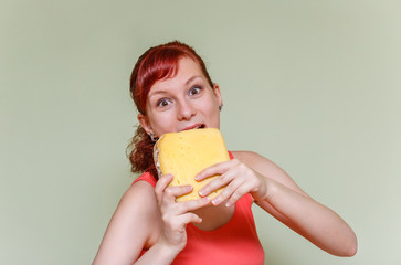 young girl bites cheddar cheese