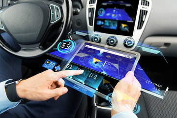 close up of man with tablet pc in car