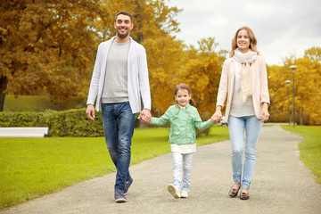 Naklejka na ściany i meble happy family walking in autumn park