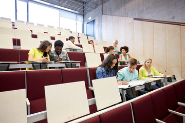 group of students with notebooks at lecture hall