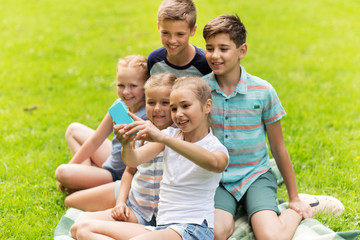 Fototapeta premium happy kids or friends taking selfie in summer park
