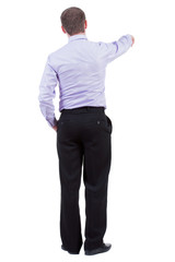 Back view of pointing business man. gesticulating young guy in black suit. Rear view people collection.  backside view of person.  Isolated over white background. office worker in a shirt and trousers