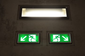 Green exit sign below light