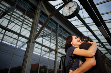 Loving couple met or parted on the platform under the clock.
