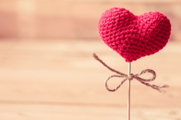 love heart yarn on wood stick with wood background.