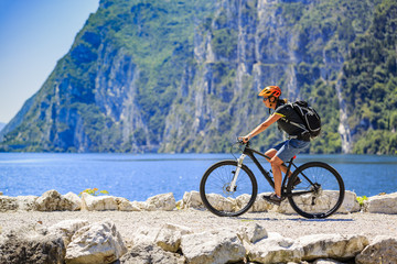 Cycling woman at the lake Shore of Garda lake in Italy