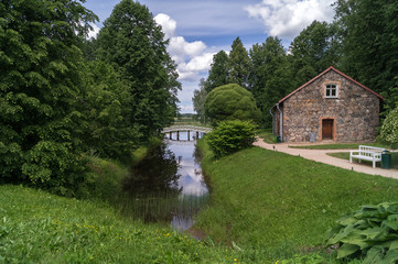 The bridge over the canal and the old house on the territory of Mikhailovskoye, Pushkin's places,...