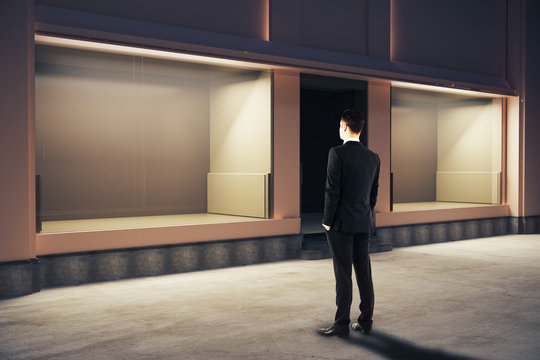Businessman looking at storefront