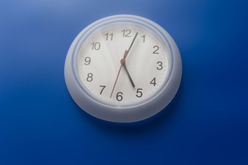 white clock on blue background