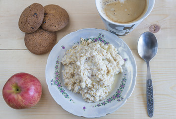 Health food. Oat, apple, oat cakes, coffee on a wooden background
