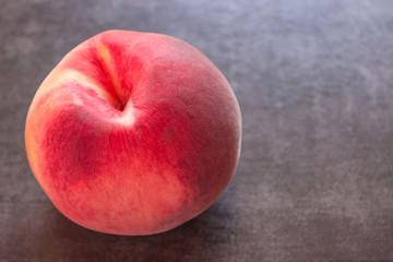 Close-up of juicy peach on a black background.