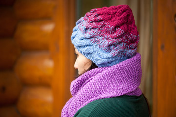 Beautiful brunette woman wearing knitted scarf and hat.