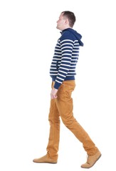 Fototapeta premium Back view of walking handsome man in jeans and striped sweater. young guy going . Rear view people collection. backside view of person. Isolated over white background.