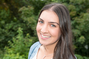 Portrait of a young beautiful woman standing outside