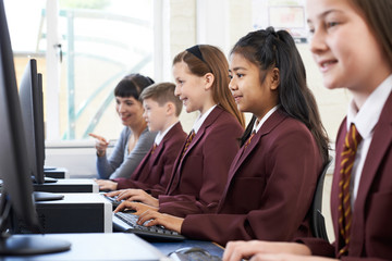 Pupils In Computer Class With Teacher - obrazy, fototapety, plakaty