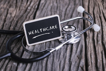 Medicine concept. Blackboard with word healthcare and stethoscope