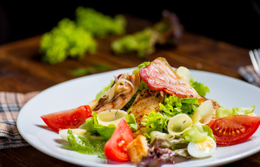plate with salad served on a wooden table