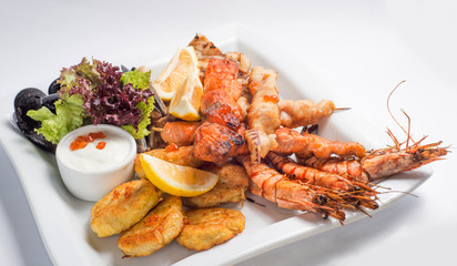 set of grilled  seafood grilled on a white plate. Serving for the restaurant menu