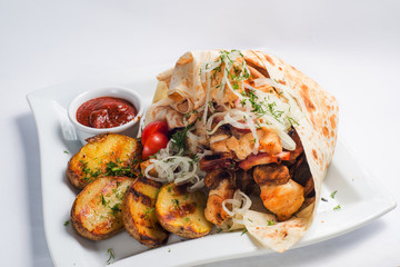 grilled meat and potatoes on a white plate. Serving for the restaurant menu