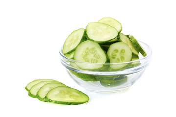 Sliced cucumber in glass bowl on white