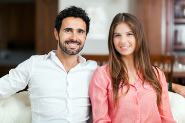 Fototapeta premium Young couple on the sofa in love
