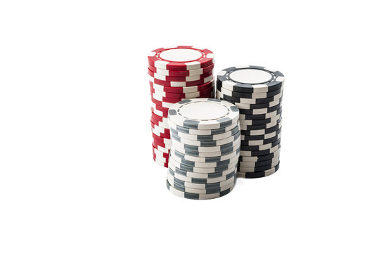 Three stacks of red, black and white casino chips isolated on white