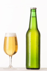 Beer bottle and glass with water drops