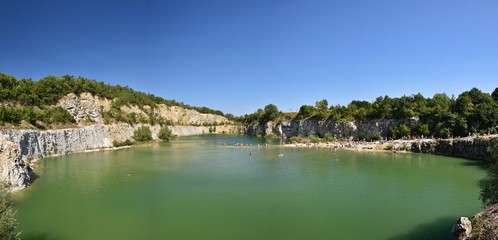 Fototapeta na wymiar Panorama of abandoned and flooded quarry. Czech Republic. Beautiful landscape with sun.