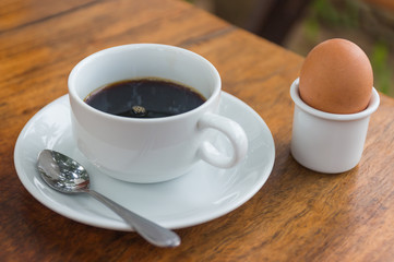 Black coffee with poached egg