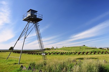 Naklejka premium Watchtower and line of defense, old state border of the Iron Curtain - barbed fence. Memorial military area - Satov Czech Republic.