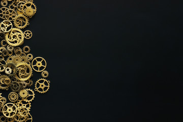 Science education or mechanical background. Old vintage gears on black chalkboard with blank for mock up for text inscription. Topview. Flatlay. Mockup.