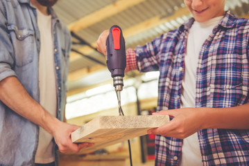 Father and son working with wood