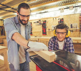 Father and son working with wood