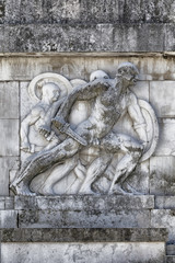 Fototapeta na wymiar Bas-relief and sculpture of ancient Roman soldiers with war scenes, Carrara marble