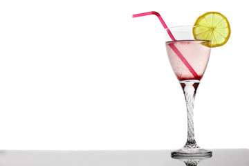 pink berries cocktail in glass with lemon and tubule on white background
