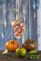 fresh Heirloom tomatoes and basil leaf isolated on blue background