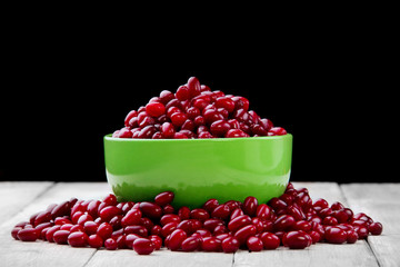 green full plate Cornelian cherries and scattered berry on the white wood board.Selective focus