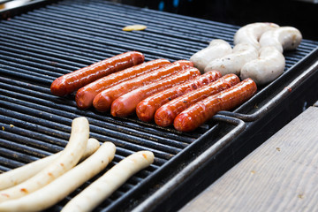 BBQ with fiery sausages on the grill