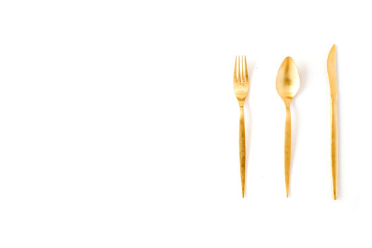 Golden Fork, Spoon, Knife Isolated On White. Flat Lay, Top View